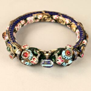 Antique Mughal silver bracelet from Benares, India, decorated with meenakari enamel and semi-precious stones, featuring two facing elephant heads on the front that can be unscrewed.<br>A period piece showing slight signs of wear and minor losses in the enamel.