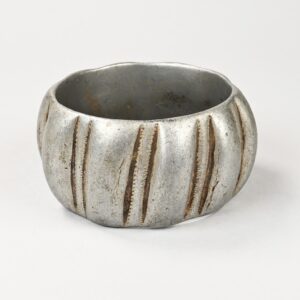 Vintage Berber aluminum bracelet with oblique engravings and aged patina, Morocco.