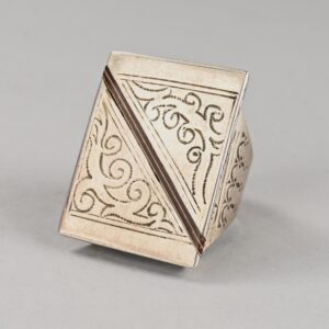 Old Tuareg silver ring finely decorated with engravings on the front surface and a diagonal line of wood and enamel inlays.