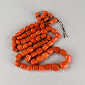 Single strand of natural red coral beads graduated from 4 to 9 mm.