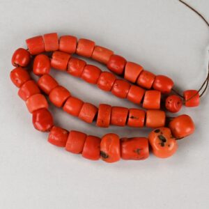 Single strand of antique graduated natural red coral beads with rich color variations, 12.2 inches long.